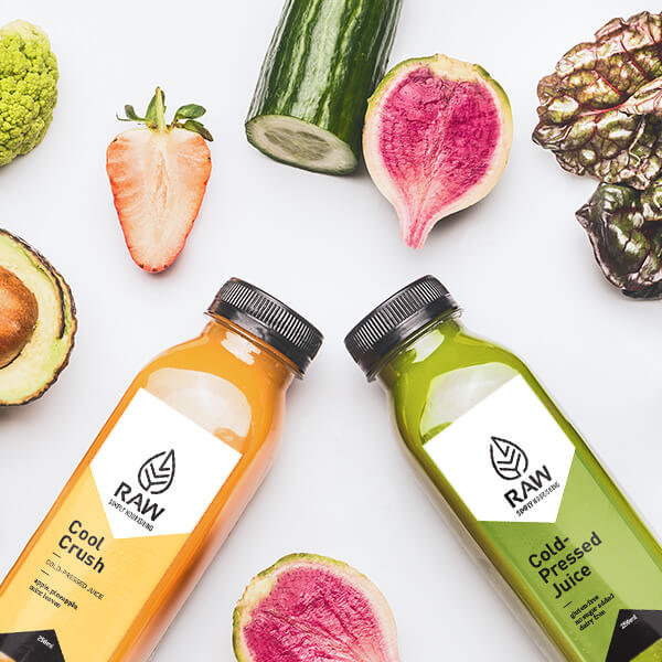 RAW ME cold-pressed juice bottles with fresh produce